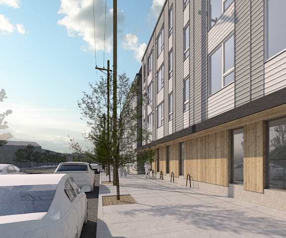 A modern building with a parking lot in front.