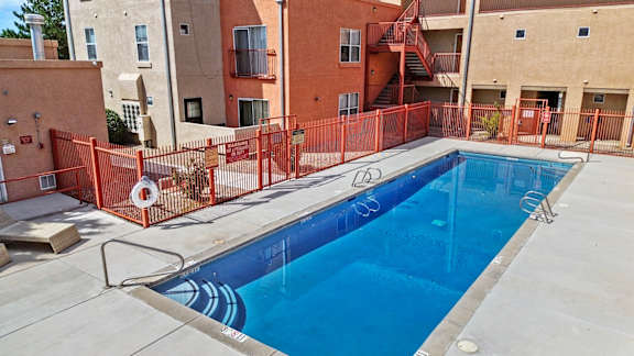 A small pool surrounded by a fence.