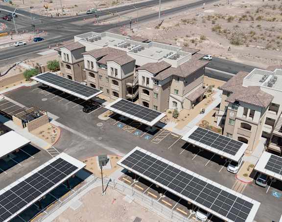 A large building with a lot of windows and solar panels on the roof.