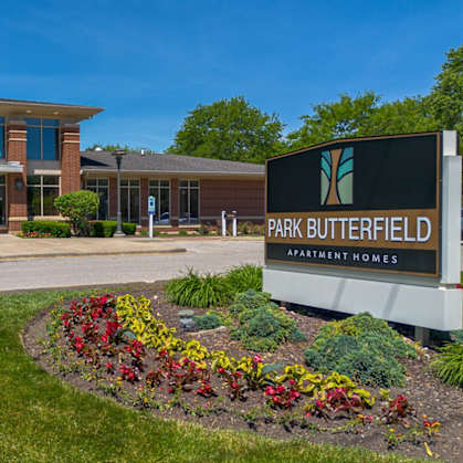 The image shows a building with a sign that reads "Park Butterfield Apartment Homes".