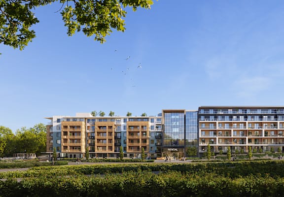 A modern apartment complex with multiple buildings and balconies.