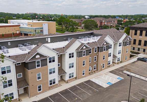 A parking lot in front of apartment buildings.