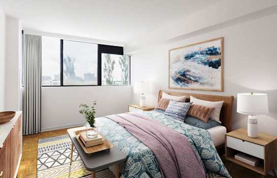 Sunny bedroom showing a bed and bench at the foot of the bed.