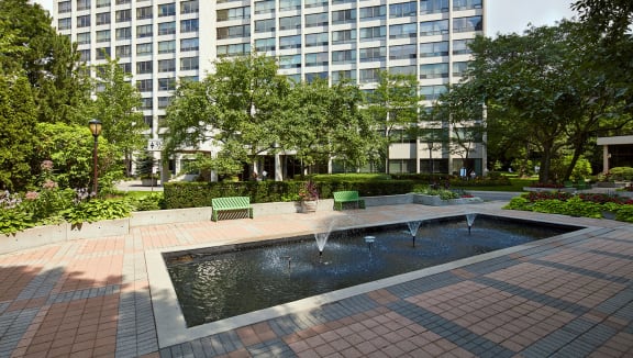 Courtyard with water feature and fountains surrounded with seating.