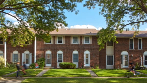 Georgian Court townhome exterior surrounded by trees.
