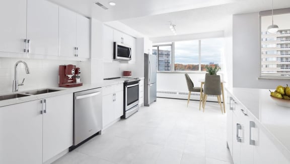 Modern suite kitchen with stainless steel appliances and quartz countertops
