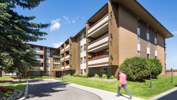 exterior image of building during the day while a person walks toward the front entrance
