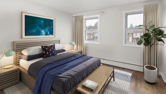 Sunny bedroom showing a bed and bench at the foot of the bed.