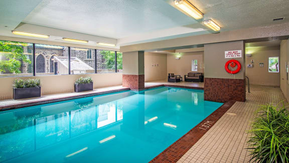 Indoor pool with surrounding seating and lounge areas.