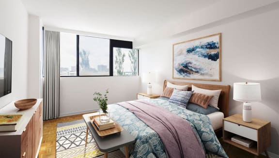 Sunny bedroom showing a bed and bench at the foot of the bed.