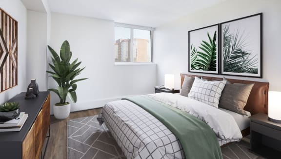 Staged bedroom with queen-sized bed and stunning city-view.