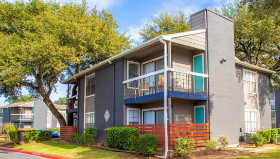 Exterior of building with patio and balcony