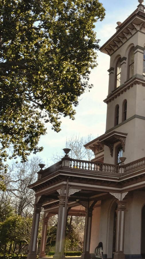a mansion with a tower on top of it