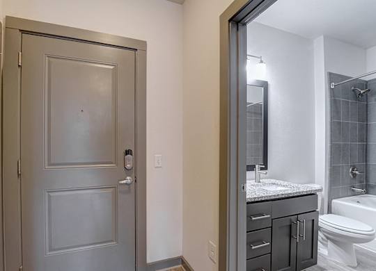 A bathroom with a toilet, sink, and shower.