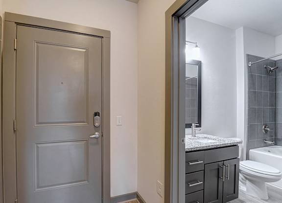 A bathroom with a toilet, sink, and shower.