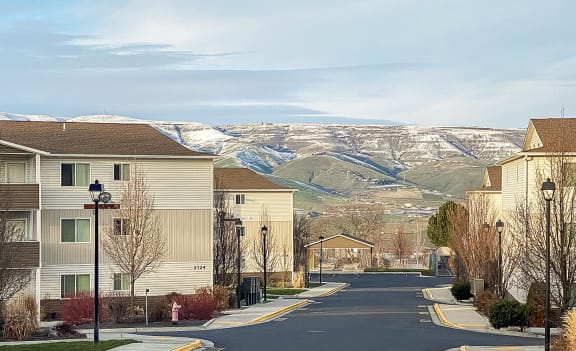 a street with houses with mountains in the background  at Canyon View, Idaho, 83501