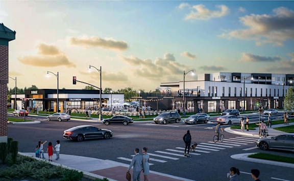 A street scene with cars, pedestrians, and cyclists.