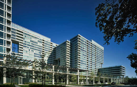 an aerial view of a tall building surrounded by trees