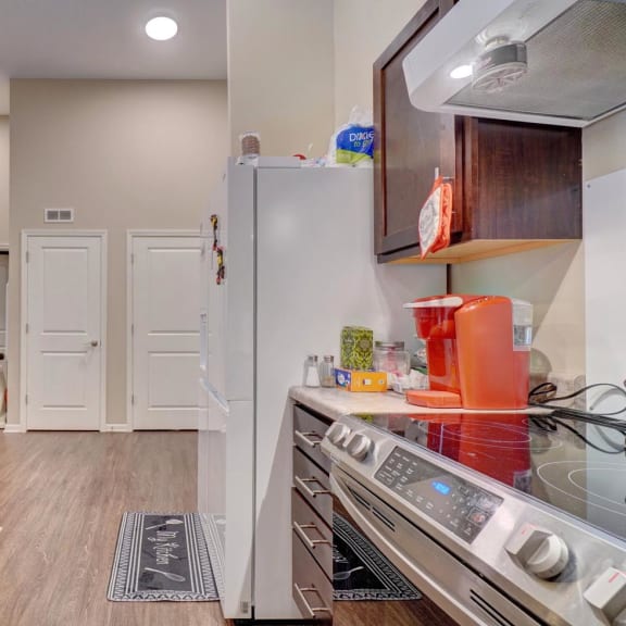 a kitchen with wooden cabinets and stainless steel appliances