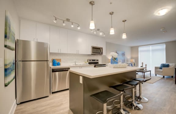 a kitchen with white cabinets and stainless steel appliances