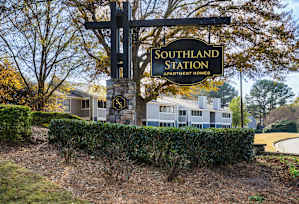 A row of houses with a grassy area in front at Southland Station Apartments, Warner Robins, 31088