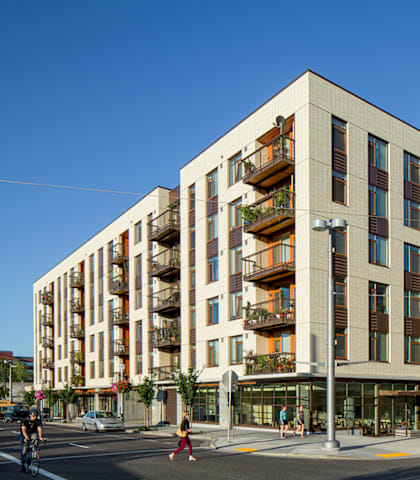 A modern building with balconies on the second floor.