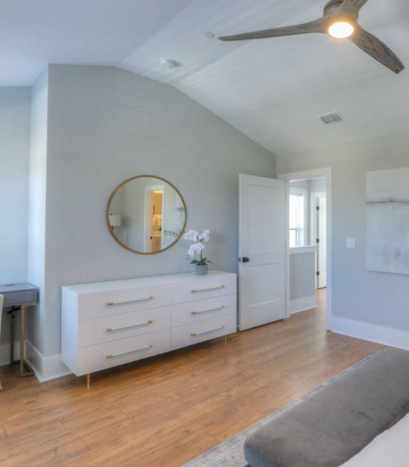 a bedroom with a bed and a ceiling fan