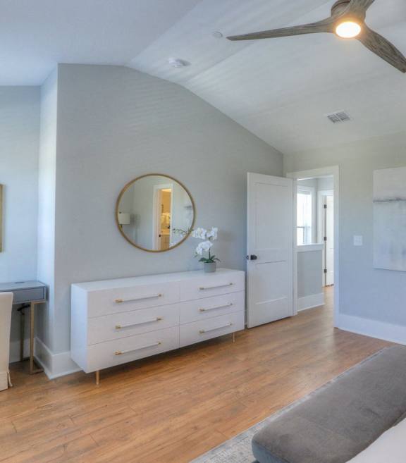 a bedroom with a bed and a ceiling fan