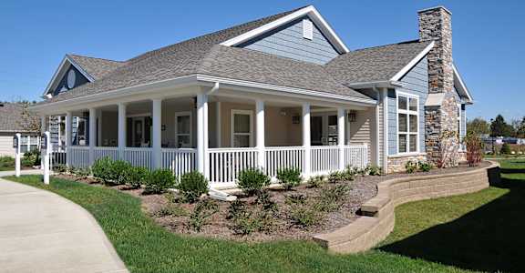 A house with a grey roof and white columns.