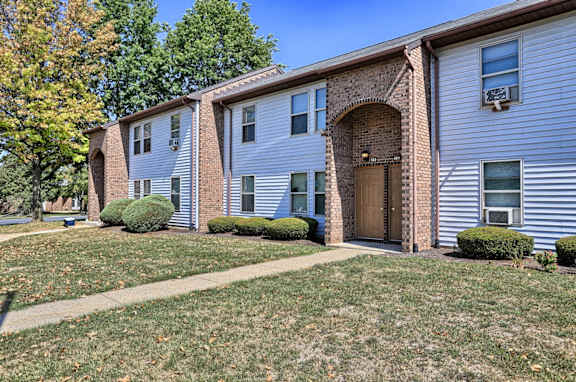 the front of a house with a sidewalk and grass