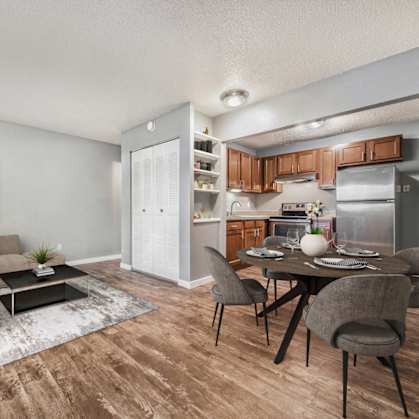 a living room and dining room with a table and chairs