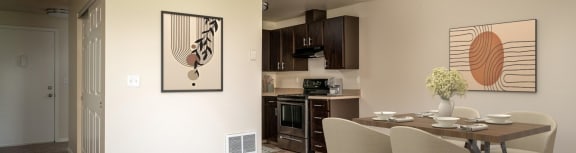an open living room and dining room with a table and chairs
