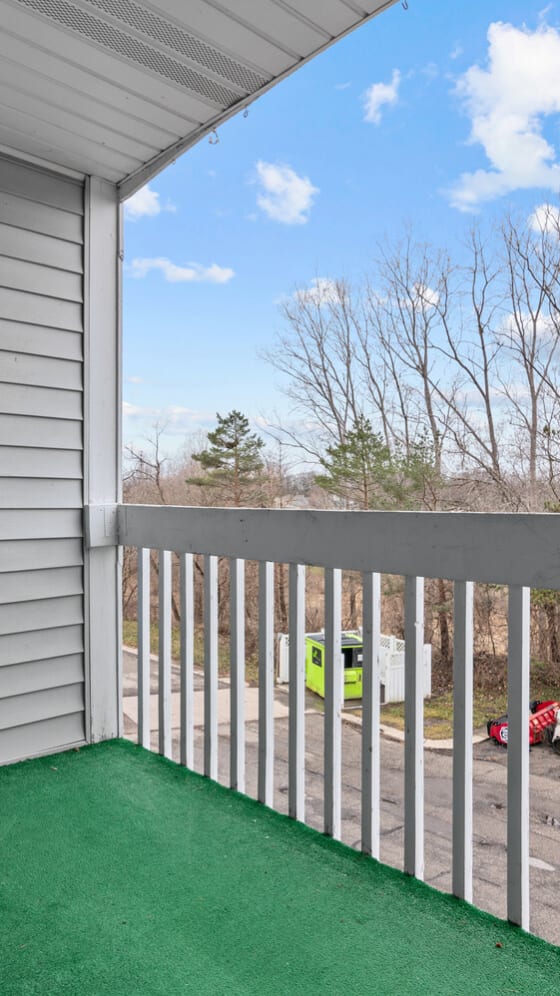 the laundry room has a washer and dryer and a door to the bathroom  at Fairfax Apartments - Lansing, MI, Michigan, 48917
