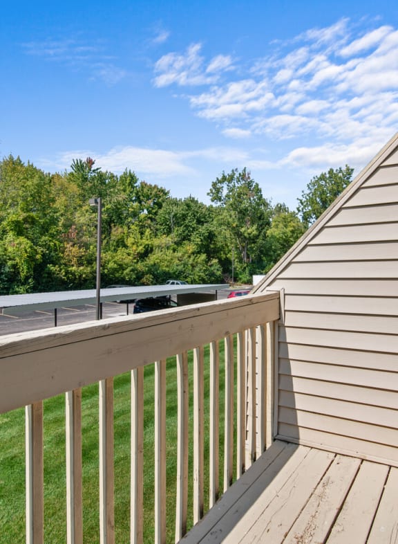 the deck of a home with a view of a yard and trees