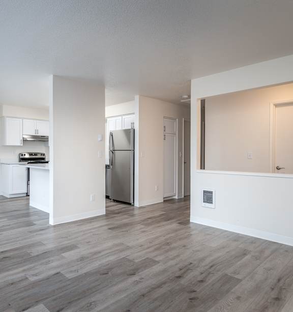 A spacious kitchen with a refrigerator, sink, and stove is visible.