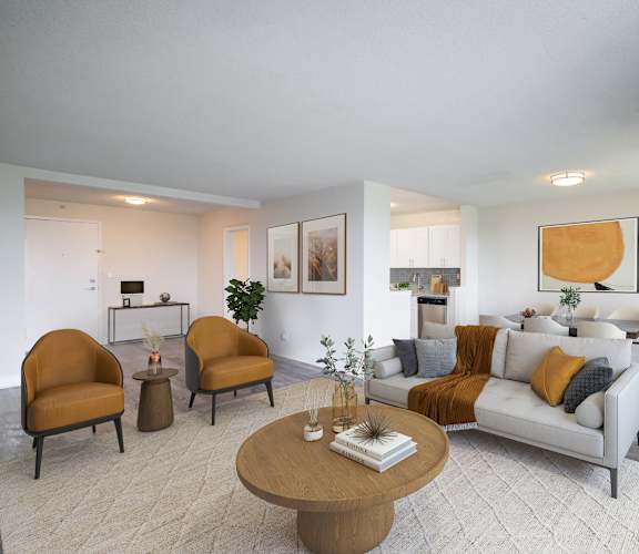 A living room with a grey couch, a brown coffee table, and a potted plant at Premier at Cherry Hill, Cherry Hill, NJ 08002