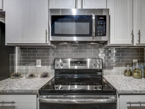 Electric Range in Kitchen at Riachi at One21, Plano, 75025