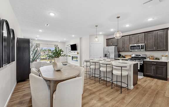 a view of a kitchen with a island and blue chairs