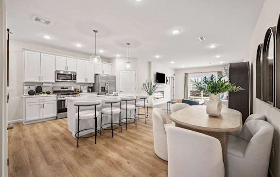 a view of a kitchen with a island and blue chairs