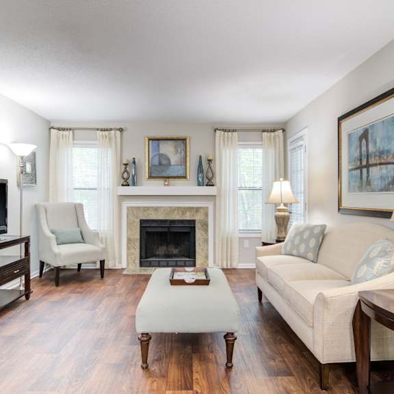 Pet-Friendly Apartments in Marietta– Wood Pointe Apartments – A living room with a fireplace and a television.