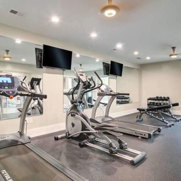 Pet-Friendly Apartments in Marietta– Wood Pointe Apartments – A gym with treadmills, elliptical machines, and a flat screen TV.