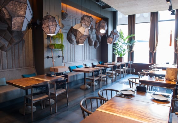 a restaurant with wooden tables and chairs