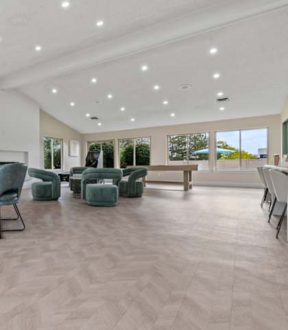 A spacious room with a dining table and chairs.