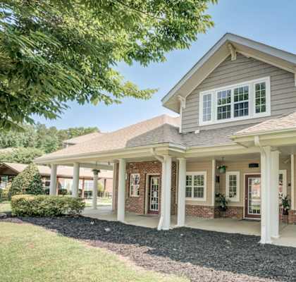 A house with a grey roof and white columns.