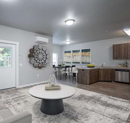 a living room and kitchen with a couch and a table