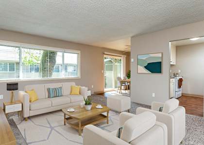 a living room with couches and chairs and a table