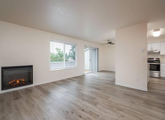 A modern living room with a fireplace and wooden flooring.