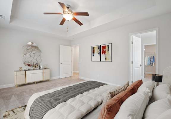 a bedroom with a large bed and a ceiling fan