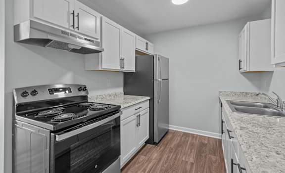 the kitchen in a new home with white cabinets and stainless steel appliances