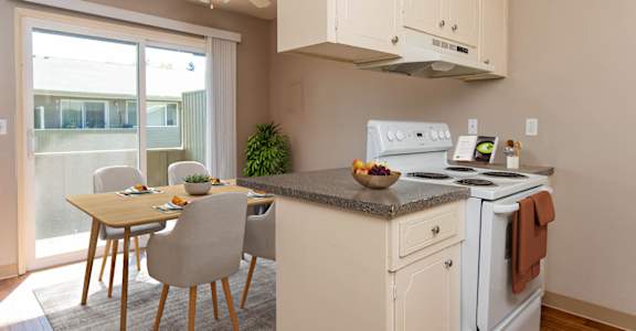 a kitchen with a table and chairs and a stove